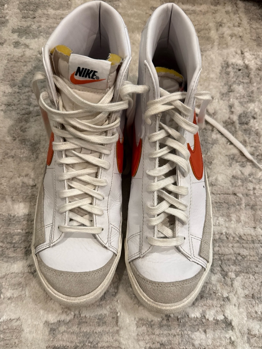 Nike White High-Top Sneakers with Orange Swoosh Accents